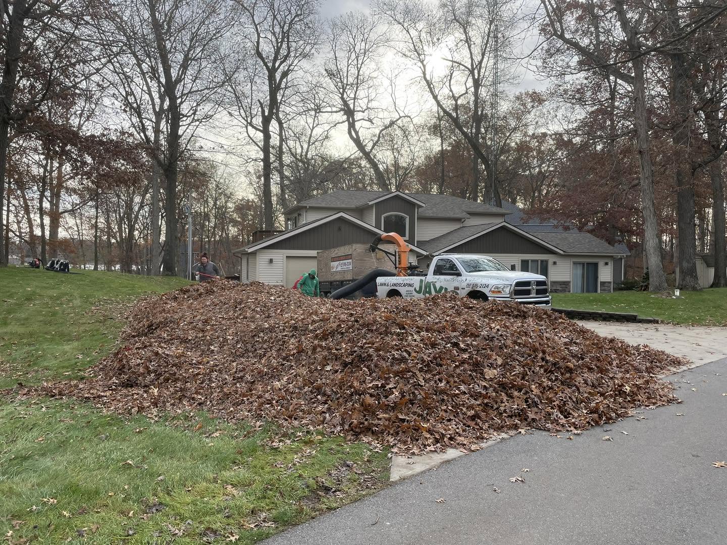 The Jay's Lawn Service crew and branded truck doing a fall leaf cleanup in Angola, Indiana